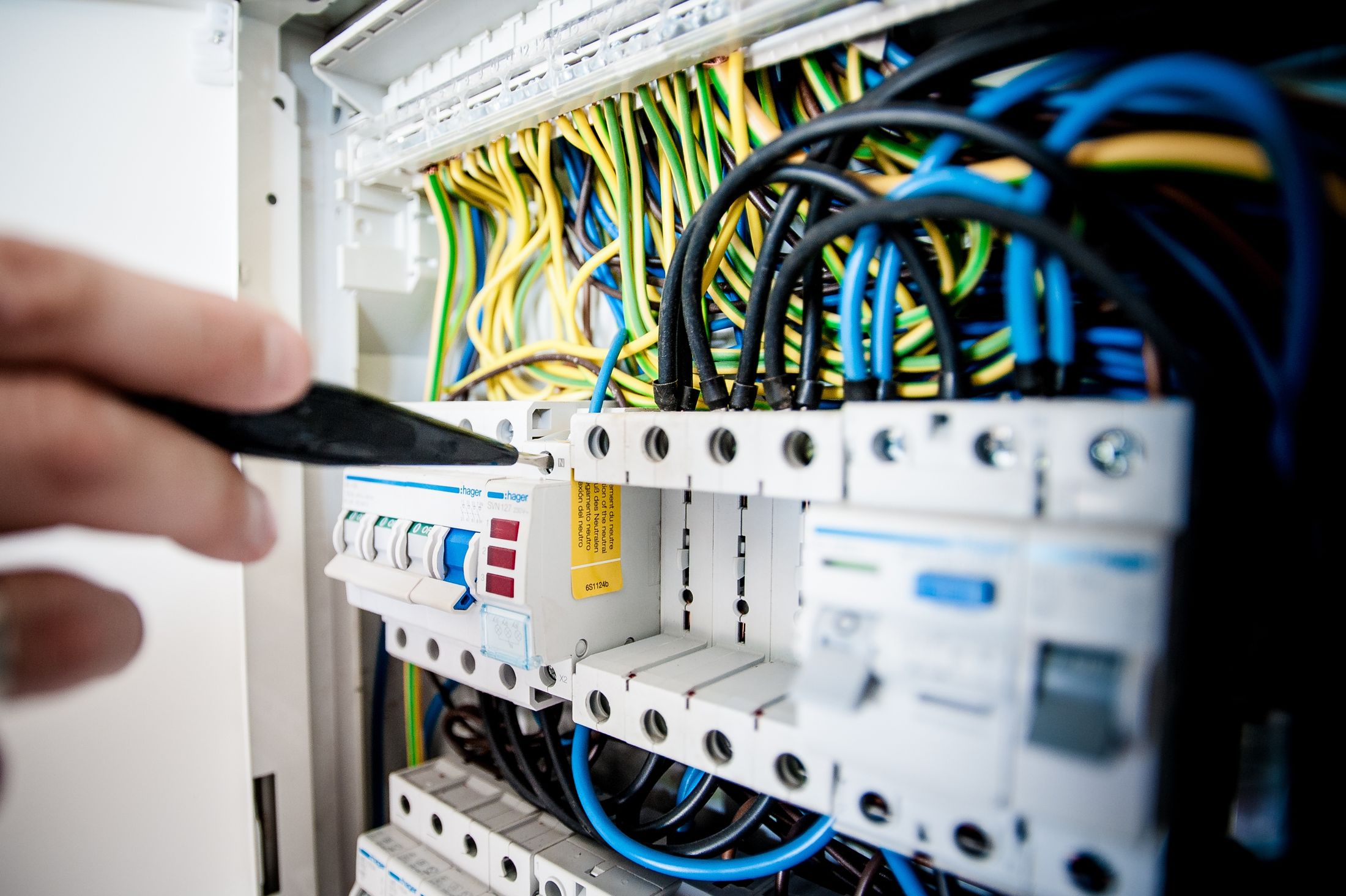 A consumer unit being worked on, with colour-coded cabling and RCD protection
