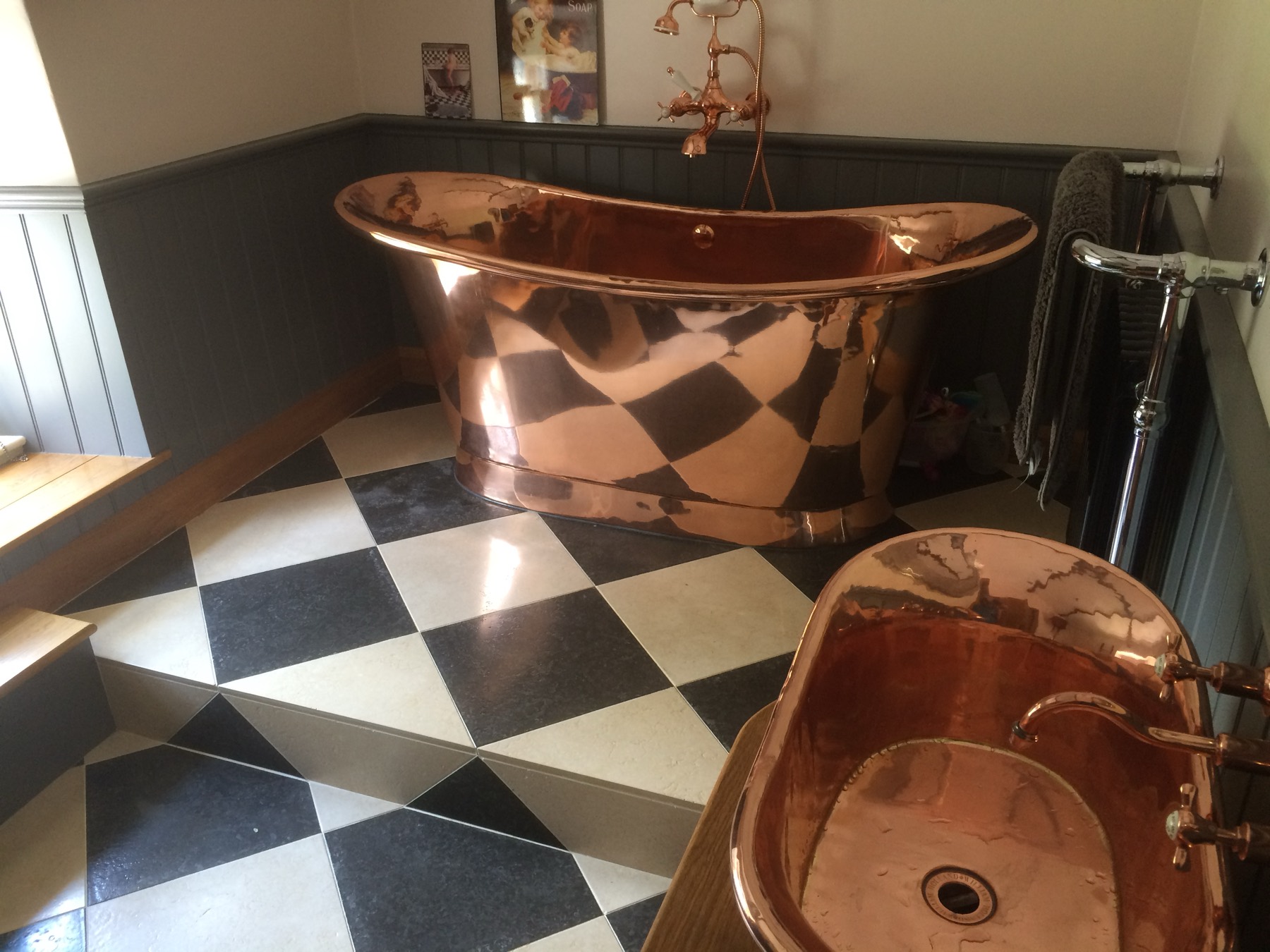 Period bathroom — lighting and heating circuits installed to suit the bathroom zones, with a freestanding copper bath in the middle of it.